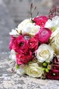 Festive wedding bouquet in grass with two golden rings