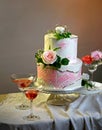 Festive wedding bunk cake decorated with fresh flowers on a dark background Royalty Free Stock Photo