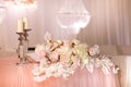 festive wedding table decoration with crystal chandeliers, golden candlesticks, candles and white pink flowers . stylish Royalty Free Stock Photo