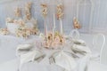 Festive wedding table setting with flowers, napkins, cutlery, glasses, bright summer table decor. Wedding decor