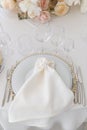 Festive wedding table setting with flowers, napkins, cutlery, glasses, bright summer table decor. Wedding decor