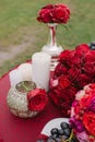 Festive wedding table setting, red roses, candles and vases at dinner Royalty Free Stock Photo