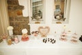 Festive wedding tables with sweets, candies, dessert and fresh flowers