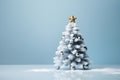 Festive white Christmas tree with decoration balls and gold star blue silver banner