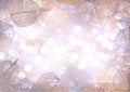 Festive winter background of bokeh lights with frame of hoarfrost leaves Royalty Free Stock Photo