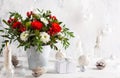 Festive winter flower arrangement in vase  and Christmas baubles on table.  and Christmas decorations Royalty Free Stock Photo