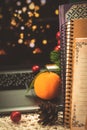 Festive winter still life with mandarin or tangerin on background of books, laptop and garlad bokeh, holidays at home