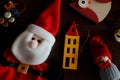 Festive winter toys and soft Santa Claus for new year tree on wooden background as winter holidays decoration.