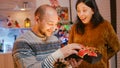 Festive woman giving present box to man celebrating christmas eve Royalty Free Stock Photo