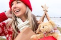 Festive woman carring Christmas things... Christmas snowy backdrop