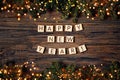 Festive wooden background with fir tree. Text in English made from wooden letters Happy New Year.