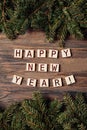Festive wooden background with fir tree. Text in English made from wooden letters Happy New Year. Royalty Free Stock Photo