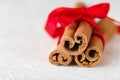 Festive wrapped cinnamon sticks with red ribbon Royalty Free Stock Photo