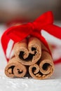 Festive wrapped cinnamon sticks with red ribbon Royalty Free Stock Photo