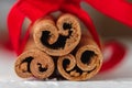 Festive wrapped cinnamon sticks with red ribbon Royalty Free Stock Photo