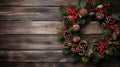 A festive wreath made up of pine cones and holly berries,