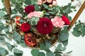 Festively decorated banquet table in the restaurant. Fresh flowers are golden candles and red chairs and garnet. expensively rich Royalty Free Stock Photo