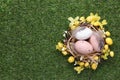 Festively decorated Easter eggs on green grass, top view. Space for text