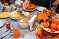 Festively laid table. Beautifully decorated dishes. Hand puts a spoon salad.