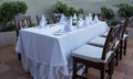 Festively laid table with white tablecloths glasses and plates Royalty Free Stock Photo