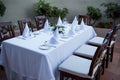 Festively laid table with white tablecloths glasses and plates Royalty Free Stock Photo