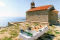 Festively served buffet table with water, champagne and fruits on plates against the background of an old brick church. Royalty Free Stock Photo