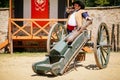 Festivities of Pernstejn Manor, Men in historical costumes are cleaning barrel of old iron cannon on wheels, Reconstruction,