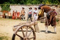 Festivities of Pernstejn Manor, Men in historical costumes are cleaning barrel of old iron cannon on wheels, Reconstruction,