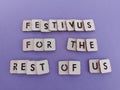 Festivus for the rest of us message on wood blocks on a purple background