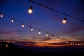 Festoon string lights decoration at the party event festival against sunset sky. light bulbs on string wire with copy space. Royalty Free Stock Photo