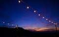 Festoon string lights decoration at the party event festival against sunset sky. light bulbs on string wire with copy space. Royalty Free Stock Photo