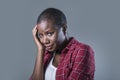 Lifestyle isolated portrait of young attractive and sad black african American woman feeling unwell and depressed and suffering pa Royalty Free Stock Photo
