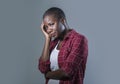 Lifestyle isolated portrait of young attractive and sad black afro American woman feeling unwell and depressed and suffering pain Royalty Free Stock Photo