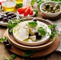 Feta cheese with the addition of olive oil, olives and herbs, close up view Royalty Free Stock Photo