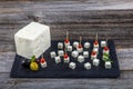 Feta Cheese Cubes on wooden cutting board. Square cubes of feta cheese isolated on wood board with knife Royalty Free Stock Photo