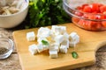 Feta cheese cut into cubes on a wooden board. Royalty Free Stock Photo
