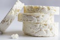 Feta cheese disk stack on white background