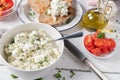 Feta cheese salad with herbs and olive oil. Served with roasted sourdough bread, tomatoes and peppers on a table Royalty Free Stock Photo