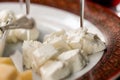 Feta cheese slices with skewers close up