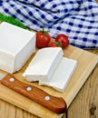 Feta cheese with tomato on the board and napkin Royalty Free Stock Photo