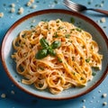 Fettuccine Alfredo pasta with cream sauce, traditional italian meal served on pastel blue plate