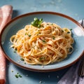 Fettuccine Alfredo pasta with cream sauce, traditional italian meal served on pastel blue plate