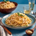 Fettuccine Alfredo pasta with cream sauce, traditional italian meal served on pastel blue plate