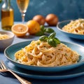 Fettuccine Alfredo pasta with cream sauce, traditional italian meal served on pastel blue plate