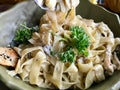 Fettuccine Alfredo Pasta Dish with Cream, Chicken and Parsley served at Restaurant. Royalty Free Stock Photo