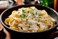 Fettuccine Alfredo - Wide egg noodles tossed in a rich and creamy Parmesan cheese sauce Royalty Free Stock Photo