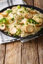 Fettuccine with fried mushrooms, cheese, broccoli and peas close Royalty Free Stock Photo