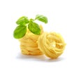Fettuccine italian pasta with basil isolated on white background. Royalty Free Stock Photo
