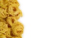 Fettuccine italian pasta isolated on white background. Raw tagliatelle nests isolated on white background. Traditional Royalty Free Stock Photo