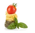 Fettuccine nest pasta with tomato cherry and basil Royalty Free Stock Photo